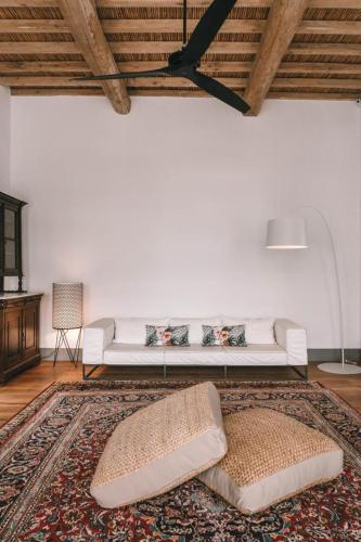 a living room with a white couch and a rug at One Manto Square in Mikonos