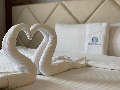 two swans made out of towels on a bed at Hotel Borea in Peje