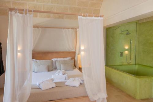 a bedroom with a bed with towels on it at Relais Masseria Villa Cenci in Cisternino