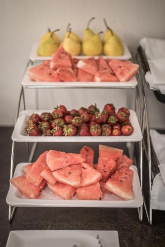 three shelves with different types of fruit on them at Lobogo Resort in Vlăhiţa