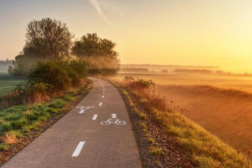 an empty road with two bikes on it at Vinoza - ubytování a vinný sklep v Moravském Toskánsku in Hovorany