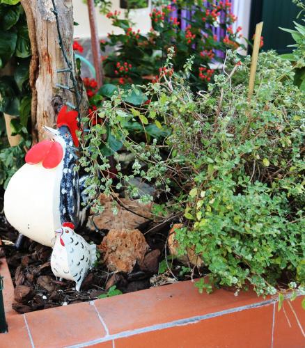 a model of a chicken in a garden at LIGURIA home in Ameglia