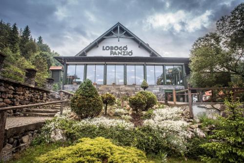 a building with a sign that reads locos panda at Lobogo Resort in Vlăhiţa