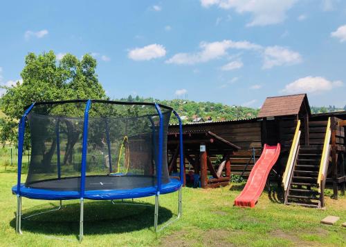 a playground with a trampoline in the grass at Apartmany Central Liptov in Liptovský Mikuláš