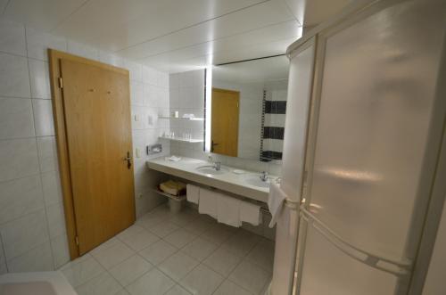 a bathroom with a sink and a mirror at Posthotel Rössle in Gaschurn