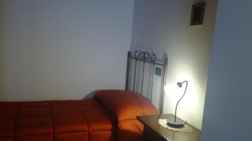 a bedroom with a bed and a lamp on a table at Antica Interamnia in Teramo
