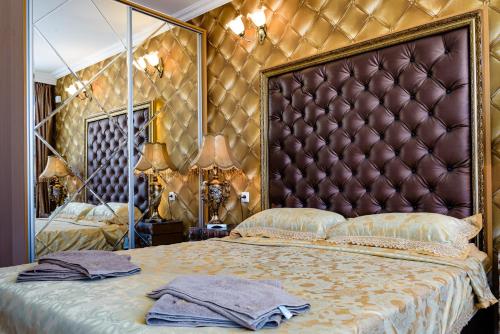 a bedroom with a large bed with a large headboard at Sweet Homes Apartments in Sunny Beach