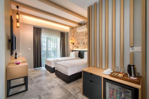 a hotel room with a bedroom with a bed and a fireplace at Isola 12 Hotel in Kas