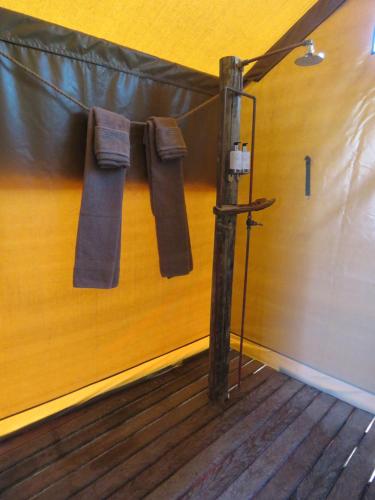 a pole with towels hanging on a wall at Woodbury Tented Camp – Amakhala Game Reserve in Amakhala Game Reserve