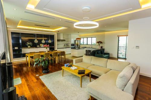 a living room with a couch and a table at Ficus Suites in Hanoi