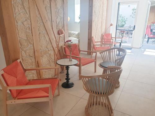 a group of chairs and tables in a room at Hôtel Brésil Opéra SPA in Paris