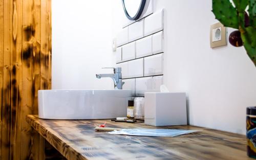 a bathroom with a sink on a wooden counter at Isola dei poeti in Marzamemi