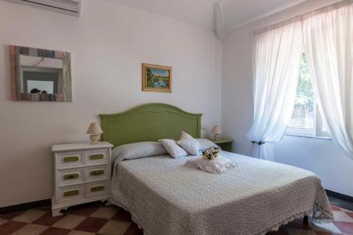 1 dormitorio con cama, tocador y espejo en La BRIGNA B&B Il bosco sul mare en Génova