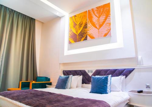 a hotel room with a bed and a painting on the wall at WINDSOR HOTEL CITY CENTER in Casablanca