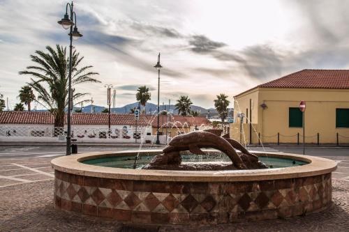 a fountain with a statue in the middle of it at Hotel Maria in Golfo Aranci