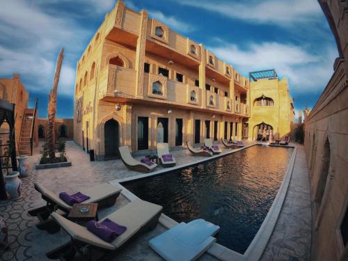 a hotel with a pool in front of a building at Casa D'or Dahab in Dahab