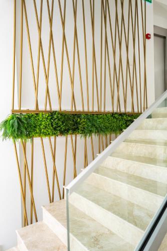 a staircase with green plants on the wall at Hotel Manor in Mamaia Nord