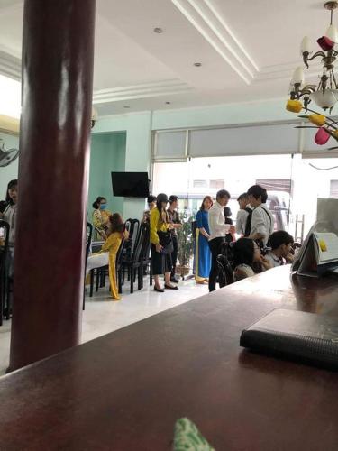 a group of people standing around in a room at Thai Binh II Hotel in Hue