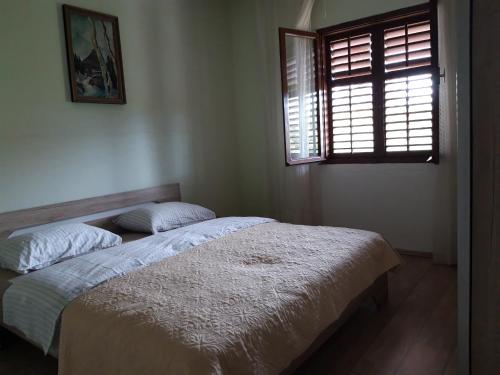a bedroom with a bed and a window in it at Apartman Adriatic BnM in Biograd na Moru