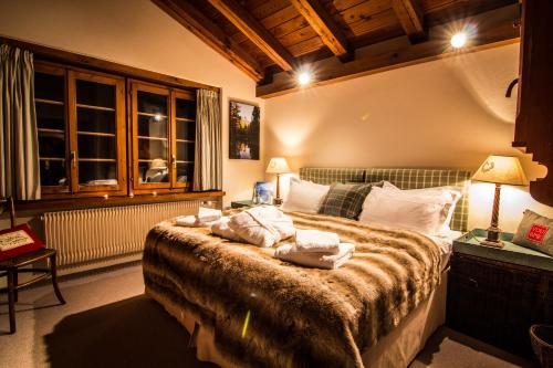 a bedroom with a bed with pillows on it at Chalet Feekatz in Saas-Fee