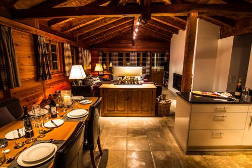 a kitchen with a table with plates on it at Chalet Feekatz in Saas-Fee