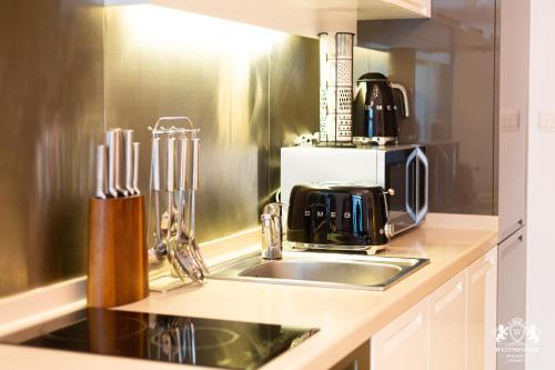 a kitchen with a sink and a coffee maker at Westminster Claren Tower - Downtown in Dubai