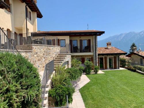 a large house with a lawn and a house at Borgo Al Tempo Perduto in Gargnano