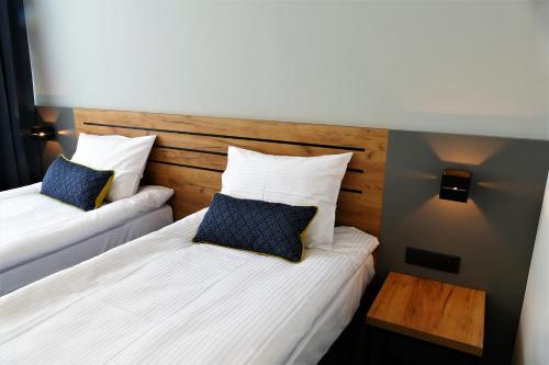 two beds in a hotel room with two pillows at Hotel Mokotów in Warsaw