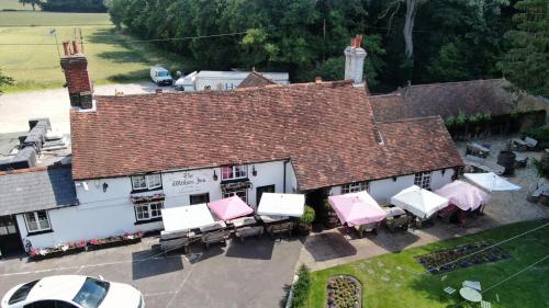 an overhead view of a building with tables and chairs at The Withies Inn in Godalming