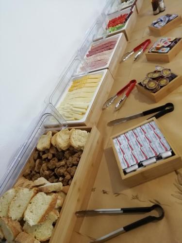 a table topped with lots of different types of food at Hill of Calm in Triopetra