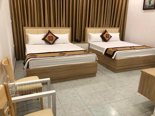 Кровать или кровати в номере Nàng Hương Motel