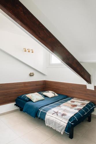 Ce lit se trouve dans un dortoir doté d'une tête de lit en bois. dans l'établissement Adorable apartment in Nice downtown, à Nice