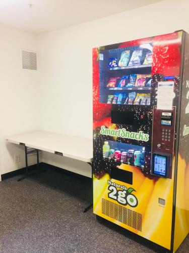 a lego vending machine next to a desk at InTown Suites Extended Stay Phoenix AZ - West in Phoenix