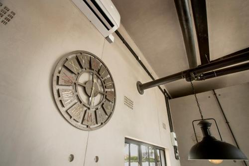 a clock on the side of a wall at The Cubes in Lusaka