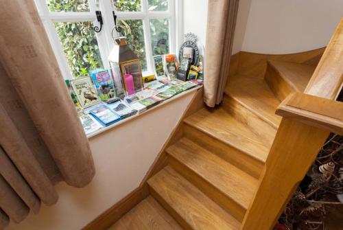 a staircase with a window and a shelf with cosmetics at Hanger Down House Bed and Breakfast in Arundel