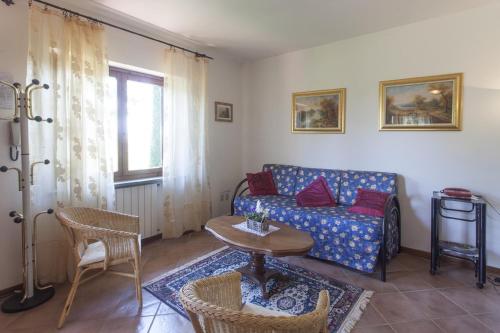 a living room with a couch and a table at Agriturismo Verbena in Castiglione del Lago