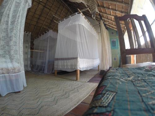 Ένα ή περισσότερα κρεβάτια σε δωμάτιο στο Mufasa Eco Lodge