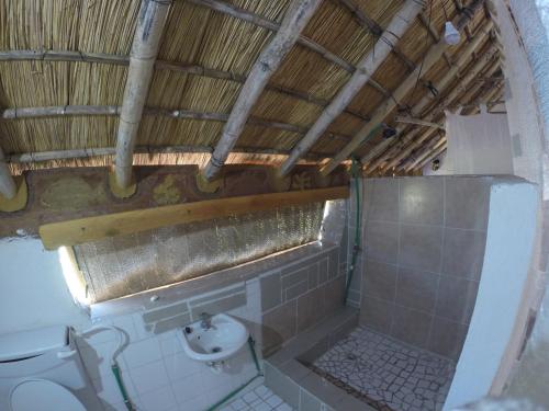 a bathroom with a toilet and a sink at Mufasa Eco Lodge in Monkey Bay