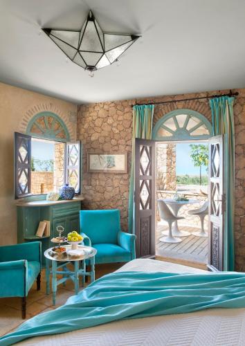 a bedroom with a bed and a patio at La Sultana Oualidia in Oualidia