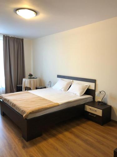 a bedroom with a bed and a table in it at Eden Blue in Costinesti