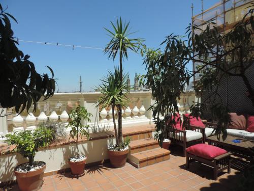 a balcony with a bunch of plants and benches at La Balaustrada, con parking incluido in Zaragoza