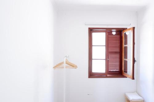 a bathroom with a window and a hanger at Kame House in Vila Nova de Gaia