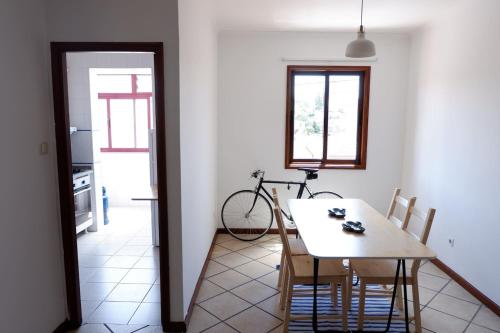 a dining room with a table and a bike at Kame House in Vila Nova de Gaia