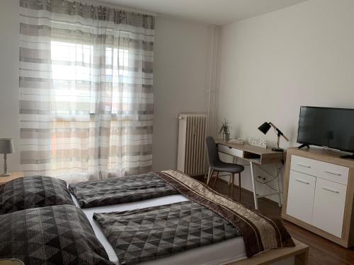 Posteľ alebo postele v izbe v ubytovaní Liliom Apartman Pécs