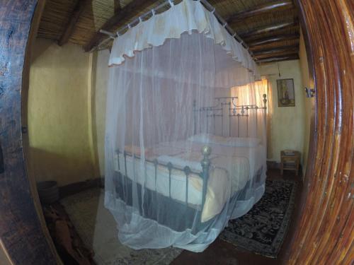 a reflection of a bed in a mirror at Mufasa Eco Lodge in Monkey Bay