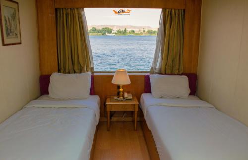 A bed or beds in a room at Nile Cruise Luxor Aswan 3,4 and 7 nights