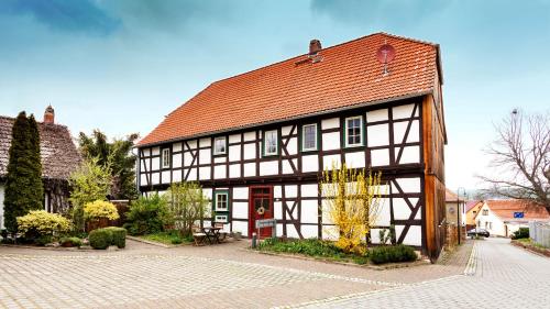 a large building with a red roof at Schwesterherz im Schlafrock in Merxleben in Bad Langensalza