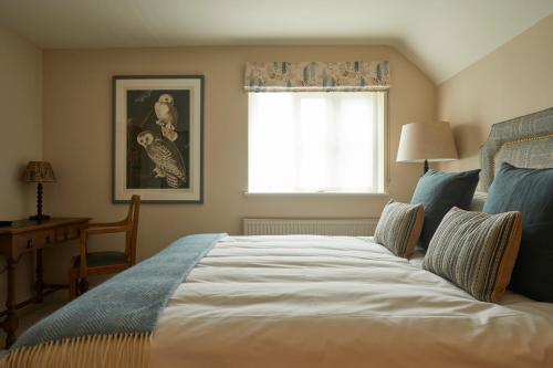 a bedroom with a large bed and a window at Crown and Anchor in Marlborough