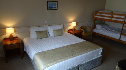 a bedroom with a bed and two bunk beds at The Lough and Quay in Warrenpoint