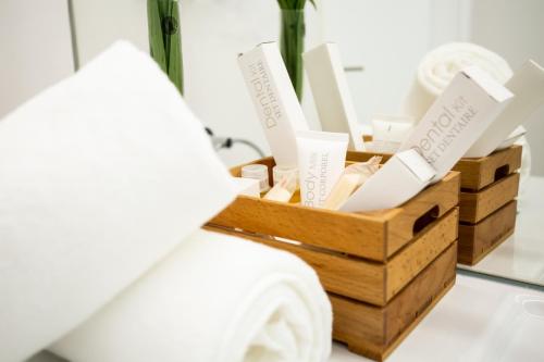 a basket of products sitting next to a bed at Plazuela del Carbón Suites in Cádiz